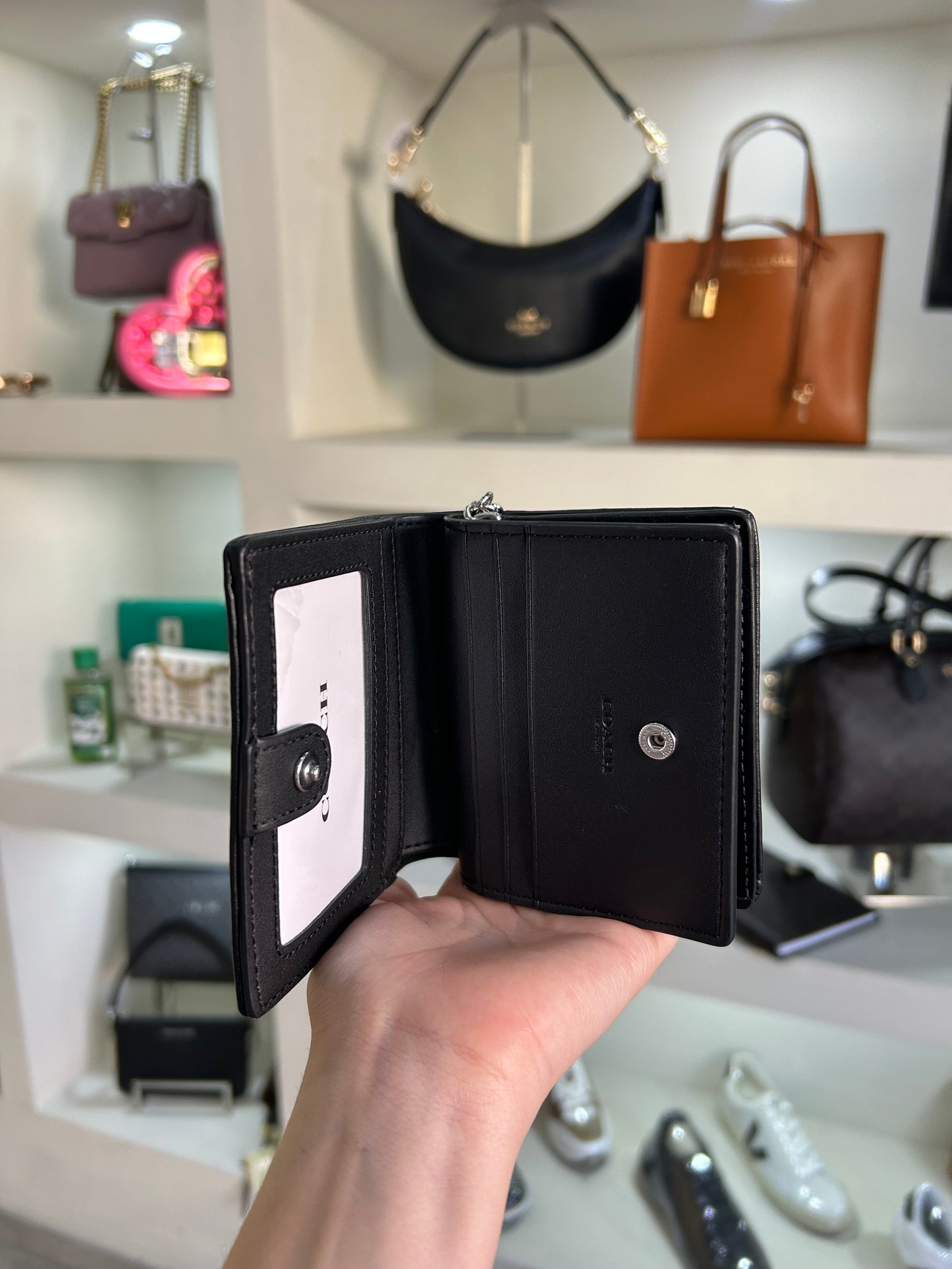 Cartera Coach negra estampada cierre alrededor